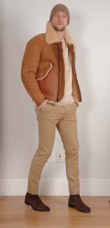  stylish ensemble featuring Earth Tones - tan chinos paired with a cream sweater, brown coach jacket, and a coordinating tan beanie. Completed with Chelsea boots, the outfit exudes a casual and fashionable vibe.